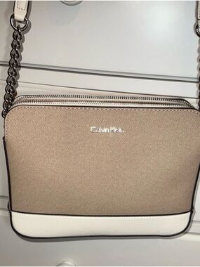 Calvin Klein crossbody bag featuring a two-tone design w/ a taupe/white color